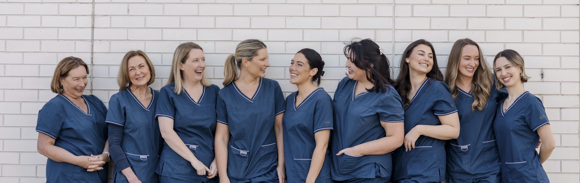 9 women in blue scrubs